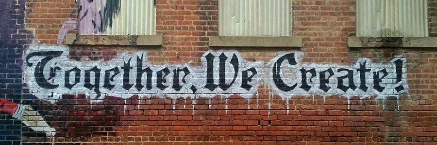 Graffiti stating, "Together We Create"