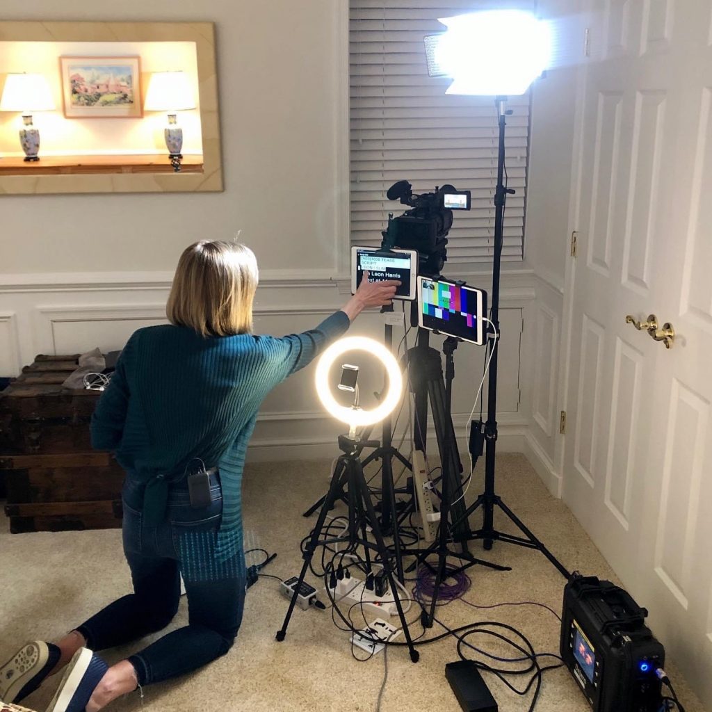 Woman setting up a video camera on set